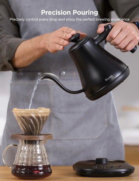 Man pouring water with a Smart Electric Kettle With WiFi And Alexa Control For Home Baristas Gooseneck Pour Over Kettle With Variable Temperature 1200W Quick Heat 0.8L Capacity One Hundred Percent Stainless Steel Matte Black into a coffee dripper.