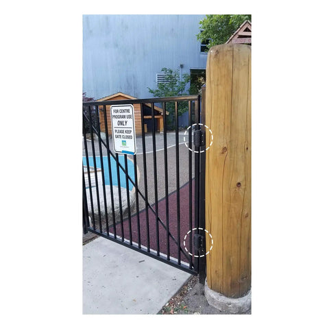 Heavy Duty Self Closing Pool And Child Safety Gate Hinges With Alignment Legs For Metal Gates chrome hinges mounted on a black safety gate.
