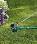 No-Fuss Half Inch Brass Impact Sprinkler With Metal Wheel Base Delivers Even Water Distribution For Lawn And Garden in use
