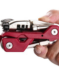 Compact red Bike Repair Multitool Kit 21 In 1 With Carry Case Portable Cycling Tool Set held in hand, side view
