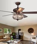 HomeStock Chrysaor 3-Light Matte Black Ceiling Fan with Crystal Chandelier and Wood Blades in cozy living room setting.