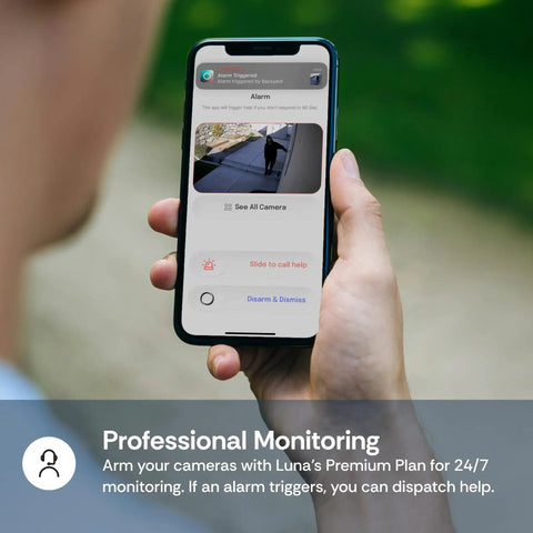Person holding phone with 2K QHD Security Camera for Indoor and Outdoor Use app showing surveillance footage and options.