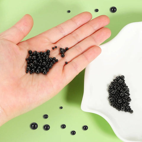 12 Pcs 5mm Silicon Nitride Ceramic Bearing Balls G10 Precision Grade shown in hand with black ceramic balls for automotive repair.