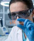 Fifty Pack Tough As Nails Safety Glasses For Crews And Jobsites Featuring Anti Fog Polycarbonate Lenses worn by lab technician.