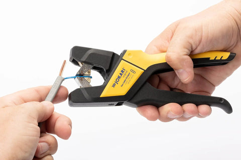Close-up of ergonomic automatic flat cable stripper for PVC insulated cables in use, stripping sheath, German quality tool.