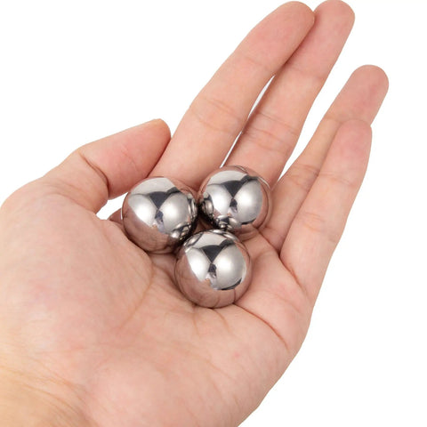 Top Shelf Precision Ground Chrome Steel Ball Bearings Three Quarter Inch Loose Pack held in hand, showing smooth finish and size.