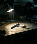 Reliable Heavy Duty Paintless Dent Puller Kit For Auto Hoods And Trunk Lids with T-bar handle on workbench under lamp