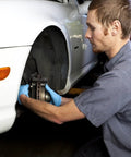 Mechanic working on car brake with internal tooth lock washers and push on fastening clips kit, 340 piece assortment setup.