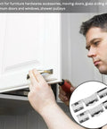 Man installing a kitchen cabinet door using the Rock Solid Eight Piece Glass Door H Pulley Roller Kit With Heavy Duty Double Bearing Sliding Wheels For Slick Patio Track Installation And Zero Hassle Replacement Setup.