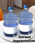 Large Marble Lazy Susan Turntable Rotating Serving Plate For Countertops And Dining Tables with two water jugs on top.