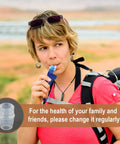 Person using blue bite valve replacement nozzle for hydration packs, BPA free silicone mouthpiece, shown with outdoor background.