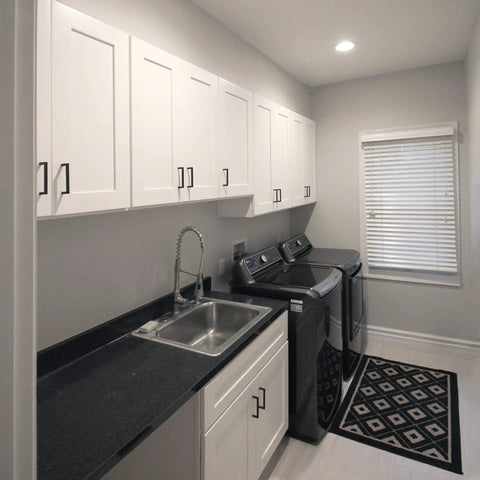 36 Inch White Corner Kitchen Cabinet With Dual Lazy Susan Spin Shelves And Smooth Operator Soft Close Doors Big Time Storage Solutions No Nonsense Daily Setup in laundry room with black countertop.