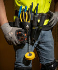 Person wearing Leather Tool Pouch Go-To 8 Pocket Carry System, holding pliers and tools, belt clip visible, knife snap shown