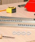 Top Shelf 100 Pack M8 Split Spring Lock Washers Crafted From Premium Stainless Steel For Heavy Duty Hardware Fixes And Rock Solid Machinery Bolt Securing Jobs on a workbench with tools.