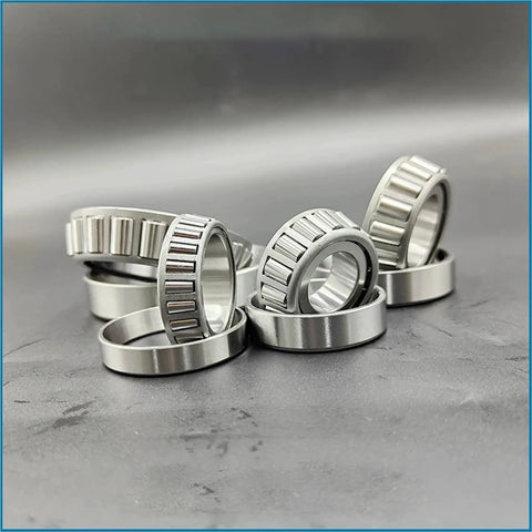 Badass Stainless Steel Tapered Roller Bearings S32014 70mm By 110mm By 25mm stacked on a surface showing their design and finish.