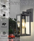 Two Pack Dusk To Dawn Outdoor Wall Lanterns With Sensor Matte Black Exterior Porch Lights E26 Base Socket Anti Rust Waterproof Weatherproof Wall Mounts For Doorway Garage Hallway Patio And Garden Ambience mounted on building wall with glowing light in rain