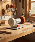 Pro Grade Dual Wheel Electric Bench Grinder on wooden workbench with polishing wheels and tools in background.