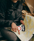 Person using Go-To Multifunction Hiking Compass With Ruler And Luminous Mirror For Camping And Outdoor Adventures on a map