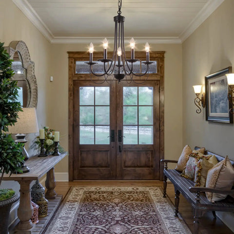Five Light Farmhouse Chandelier In Black With Classic Candle Ceiling Light Fixture in entryway with wooden double doors