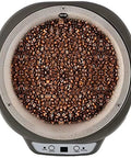 Top view of Knock Yourself Out Electric Coffee Roaster Machine With Precision Timer And Heat Dial Black with roasted coffee beans.
