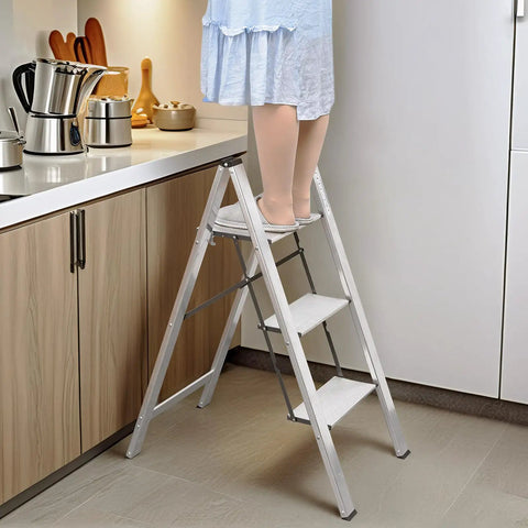 Person using Three Step Aluminum Folding Ladder For Indoor And Outdoor Tasks Space Saving Slim Fold To Four Centimeter Flat