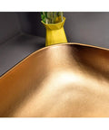 Heavy Duty Rectangular Vessel Sink Installed Above Counter From Porcelain Ceramic With A Sleek Closed Glaze showcasing a smooth gold finish.