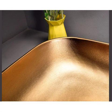 Heavy Duty Rectangular Vessel Sink Installed Above Counter From Porcelain Ceramic With A Sleek Closed Glaze showcasing a smooth gold finish.