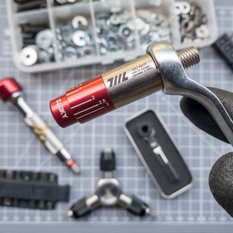 Pocket Size Precision Torque Driver With Mini Indexed Wrench And Variable Torque Control Works With Quarter Inch And Twelve Millimeter Sockets The On The Go Tool For Bike Drone RC Electronics And Tiny DIY Projects held with tool kit in background