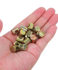 Super Cool 100 Pack M6 Threaded Inserts For Furniture Nuts Screws And Bed Connectors shown in hand, metallic light brown, used for furniture repair.