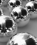 Get Top Shelf Performance With These Bad Ass High Precision G Twenty Five Grade Chrome Steel Ball Bearings Measuring One Point Five Inch In Diameter Hot Forged For Ultimate Durability And Reliability Perfect For Heavy Duty Applications, close-up view of polished chrome steel ball bearings.