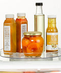 Slick Rotating Lazy Susan Turntable Spinner Fully Swiveling 11.5 Inch Clear Plastic Round Organizer with sauces in fridge.