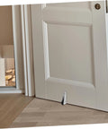 Heavy Duty Five Pack Sliding Door Bottom Guide Rollers With Slick Black Nylon Wheels And Rock Solid Steel Build For A Buttery Smooth Glide Across Universal Tracks With Easy Peasy Installation shown on a door.
