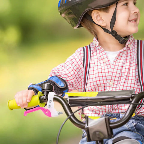 Child riding bike with Kids Bike Brake Lever Set, 2 Pack Universal Brake Handles For Kids Bikes in rosy color installed.