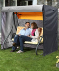 Couple sitting on a swing with Triple Seater Hammock Swing Cover For Outdoor Use Waterproof And UV Resistant All Weather Shield 81x49x67 Inches