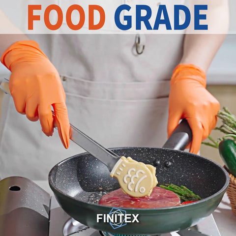 Orange nitrile disposable gloves (FINITEX) worn while cooking in a frying pan.