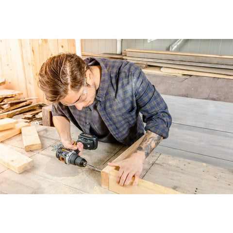 Man using Compact 1/2 Inch 20V Cordless Drill Driver Featuring Brushless Motor And Adjustable Torque Settings on wood.