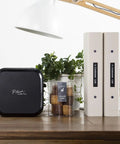 P-Touch CUBE Plus Bluetooth Label Maker PT-P710BT Portable Label Printer on desk with binders and plants