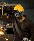 Job Site Tough Flip Up Welding Safety Glasses With Vented Anti Fog Shell Double Layer Shatterproof Lenses For Stick Mig Argon Cuts And Everyday Shop Grinds 2 Pack worn by a worker with yellow helmet.