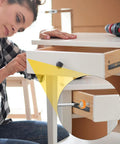 Woman installing 6 Pack Nylon Drawer Rollers 22mm Swivel Bearing Wheels on a drawer for smooth sliding.