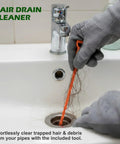 Man using Badass Heavy Duty Drain Snake And Auger With Drill Attachment Plumbing Tool 9.8Ft Galvanized Steel Spring to clear sink.