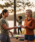 Two people using Grab and Go Disposable Soap Sheets Set, 5 Boxes on a camping trip by a lake