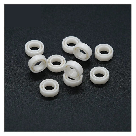Premium MR74 4x7x2.5 Millimeter Full Ceramic Zirconia Sealed Ball Bearing set on black background.