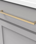 Solid Core Kitchen Cabinet Pulls In Brushed Golden Brass, 12 Inch Hole Center mounted on a gray cabinet, Skylight Collection