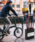 Dual Battery Parallel Module For E Bikes With 20V To 72V Input And Output, 40A Max, XT60H M Plug, shown next to cyclist