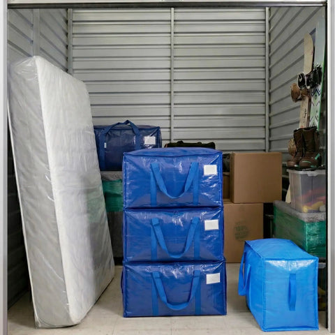 Ultra Large Moving Bags With Heavy Duty Zippers And Sturdy Carry Handles Waterproof Storage Bags For Moving Closet Organization And Camping 16 Pack Blue in storage unit with mattress and cardboard boxes.