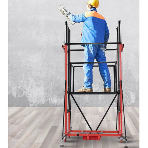 Person using Workhorse Multifunctional Scaffolding System with Remote Control and Wheels for indoor painting task.