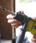 Close-up of a hand operating the quick release chuck of the Compact Hammer Drill With Variable Speed Trigger And Reversal Built.