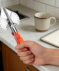 Hand holding Pro Grade Multi Angle Miter Shear Cutter with 8.3 Inch Blade, adjustable 45 to 135 degrees, bright orange handle.