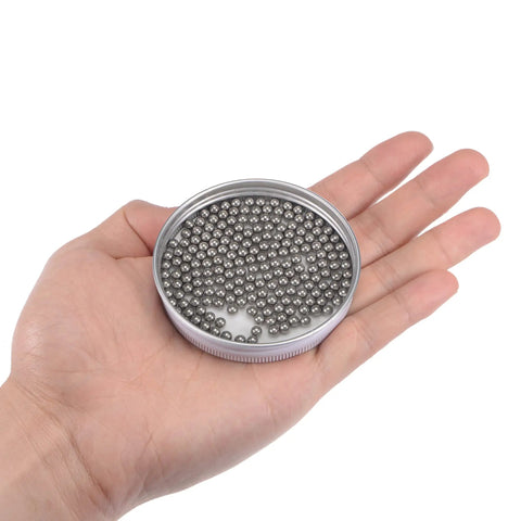 Hella Smooth 4Mm 304 Stainless Steel Ball Bearings G100 Precision Grade in hand, showing package of two hundred metal balls.
