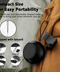Pocket Sized Bluetooth Speaker With Deep Bass And Crisp Highs, 5W Stereo Sound, True Wireless Stereo Pairing, IP7 Waterproof, shown attached to bag with lanyard.